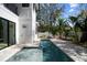Modern home featuring a rectangular in-ground pool, patio, and tropical landscaping at 2318 Bay St, Sarasota, FL 34237