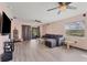 Relaxing living room featuring hardwood floors and ceiling fans at 424 Logue Rd, Myakka City, FL 34251
