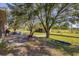 Spacious backyard with hot tub, patio, and mature trees at 424 Logue Rd, Myakka City, FL 34251