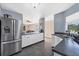 Open concept kitchen with stainless steel refrigerator and granite countertops at 424 Logue Rd, Myakka City, FL 34251