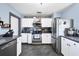 Bright kitchen featuring stainless steel appliances and white cabinets at 424 Logue Rd, Myakka City, FL 34251