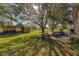 Large backyard with patio, outbuildings, and lush greenery at 424 Logue Rd, Myakka City, FL 34251