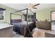 Spacious bedroom with a canopy bed and dresser at 424 Logue Rd, Myakka City, FL 34251