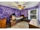 Bedroom with purple walls, window seat, and built-in shelving at 424 Logue Rd, Myakka City, FL 34251