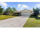 Single-story house with attached garage and driveway, surrounded by trees at 4601 Ulster Ave, North Port, FL 34287