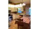 Cozy kitchen with light cabinets, a small table, and wood floors at 4601 Ulster Ave, North Port, FL 34287