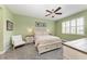 Light and airy bedroom with a queen-size bed, ceiling fan, and ample closet space at 2974 Trustee Ave, Sarasota, FL 34243