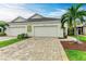 Two-car garage with paver driveway and landscaping at 2974 Trustee Ave, Sarasota, FL 34243