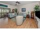 Living room showcasing comfortable seating, hardwood floors, and access to patio at 232 Woodland Dr, Osprey, FL 34229