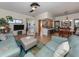 Bright and airy living room with light teal couches and a large TV at 232 Woodland Dr, Osprey, FL 34229