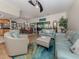 Living room with comfortable seating, hardwood floors and access to a patio at 232 Woodland Dr, Osprey, FL 34229
