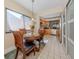 Charming breakfast nook with a round table and four chairs at 232 Woodland Dr, Osprey, FL 34229