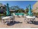 Relaxing pool area with tables, chairs and umbrellas at 232 Woodland Dr, Osprey, FL 34229