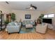 Spacious living room with light teal sofas and wood floors at 232 Woodland Dr, Osprey, FL 34229