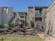 Condo building exterior featuring a courtyard and landscaping at 232 Woodland Dr, Osprey, FL 34229