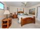 Comfortable bedroom with a wooden bed frame and ceiling fan at 232 Woodland Dr, Osprey, FL 34229