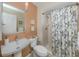 Small bathroom with a shower stall and peach colored walls at 232 Woodland Dr, Osprey, FL 34229