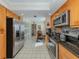 Bright kitchen boasts stainless steel appliances and light wood cabinets at 232 Woodland Dr, Osprey, FL 34229