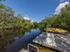 Wooden dock with kayak and tranquil waterway views at 232 Woodland Dr, Osprey, FL 34229