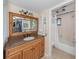 Clean bathroom with a vanity, granite countertop and shower/tub combo at 232 Woodland Dr, Osprey, FL 34229