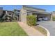 Covered parking for two cars with lush green landscaping at 232 Woodland Dr, Osprey, FL 34229