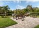Tranquil waterfront seating area with benches and fire pit at 232 Woodland Dr, Osprey, FL 34229