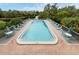 Community pool with plenty of lounge chairs and patio furniture at 232 Woodland Dr, Osprey, FL 34229