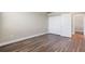 Bright bedroom with double doors to the closet and wood-look floors at 11332 Rivers Bluff Cir, Lakewood Ranch, FL 34202