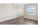 Spacious bedroom with wood-look floors and a window at 11332 Rivers Bluff Cir, Lakewood Ranch, FL 34202