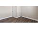 Spacious bedroom with wood-look floors and an interior door at 11332 Rivers Bluff Cir, Lakewood Ranch, FL 34202