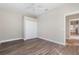 Bedroom with double doors to the closet and wood-look floors at 11332 Rivers Bluff Cir, Lakewood Ranch, FL 34202