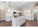 Modern kitchen with white cabinets, quartz countertops, and stainless steel appliances at 11332 Rivers Bluff Cir, Lakewood Ranch, FL 34202