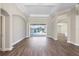 Spacious living room with hardwood floors and sliding glass doors leading to the pool at 11332 Rivers Bluff Cir, Lakewood Ranch, FL 34202