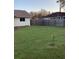 Spacious grassy backyard enclosed by a wooden fence at 4601 Ulster Ave, North Port, FL 34287