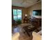 Bright living room featuring hardwood floors, large window, and comfortable seating at 4601 Ulster Ave, North Port, FL 34287