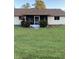 Rear view of house with screened porch and neat lawn at 4601 Ulster Ave, North Port, FL 34287