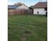 Large grassy backyard with a wooden fence at 4601 Ulster Ave, North Port, FL 34287