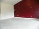 Living room with a red accent wall and concrete flooring at 2086 Kings Palace Dr # 2086, Riverview, FL 33578