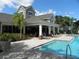 Community pool with lounge chairs and covered patio at 2086 Kings Palace Dr # 2086, Riverview, FL 33578