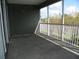 Screened lanai with view of trees and road at 2086 Kings Palace Dr # 2086, Riverview, FL 33578