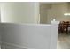 White wall separating rooms with a view of a dining area at 2086 Kings Palace Dr # 2086, Riverview, FL 33578
