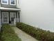 Townhome entry with walkway, shrubs, and white railings at 2086 Kings Palace Dr # 2086, Riverview, FL 33578