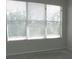 Empty bedroom with a large window and blinds; new flooring needed at 2086 Kings Palace Dr # 2086, Riverview, FL 33578