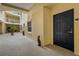 Building hallway with a black door to a condo unit at 14041 Bellagio Way # 214, Osprey, FL 34229
