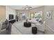 Spacious living room with balcony access and modern furniture at 14041 Bellagio Way # 214, Osprey, FL 34229