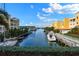 Tranquil canal view featuring boats and waterfront buildings at 14041 Bellagio Way # 214, Osprey, FL 34229