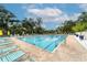 Inviting community pool with lounge chairs and umbrellas at 3905 Oakley Greene # 24, Sarasota, FL 34235