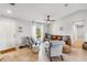 Bright living room with leather sofa and two armchairs, hardwood floors, and a large window at 6771 Topeka Ln, North Port, FL 34291