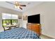 Bedroom with queen bed, dresser, and flat-screen TV at 5812 Willow Marsh Ct, Sarasota, FL 34238