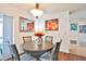 Bright dining room with round table and four chairs, hardwood floors, and wall art at 7207 13Th W Ave, Bradenton, FL 34209